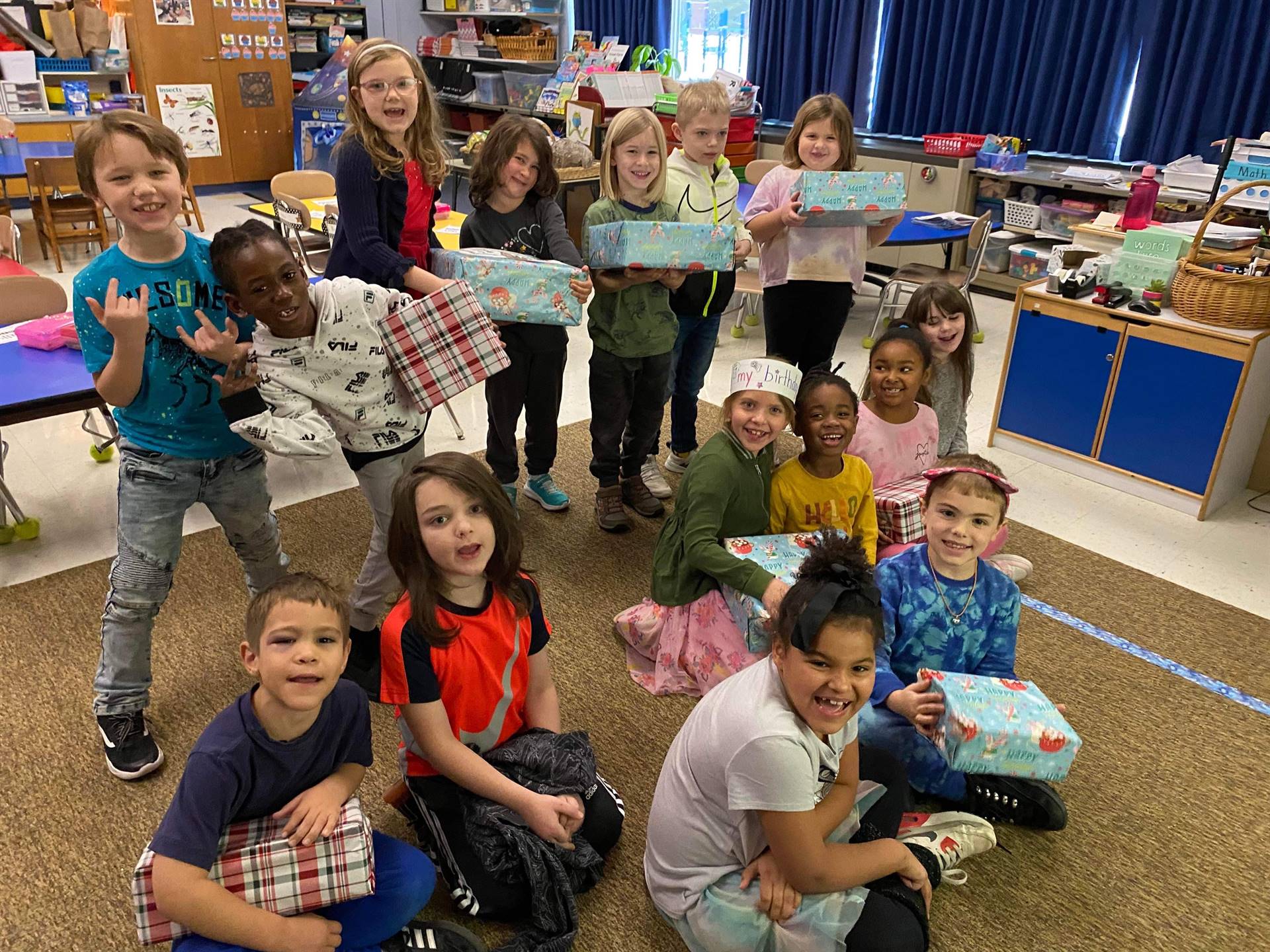 first graders holding gifts